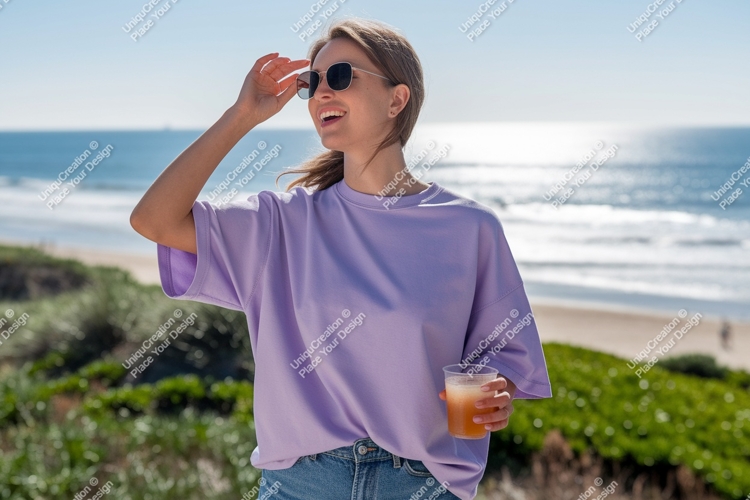 Woman wearing purple t shirt holding drink at beach