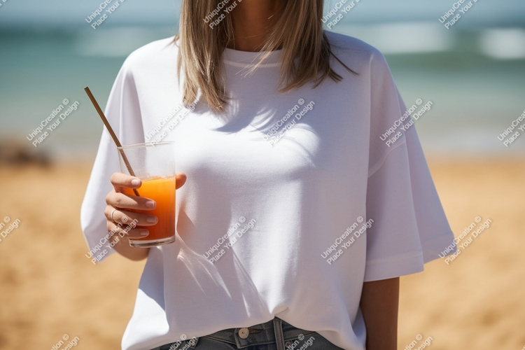 Woman holding orange drink on beach image