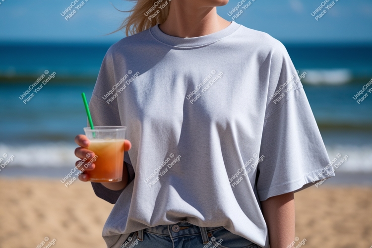 Woman holding drink on beach ocean