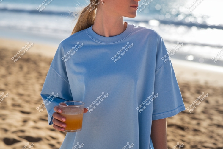 Blue shirt person holding drink beach image