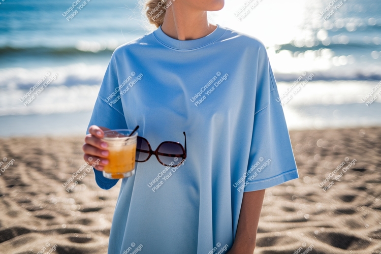 Woman holding drink and sunglasses on beach sand