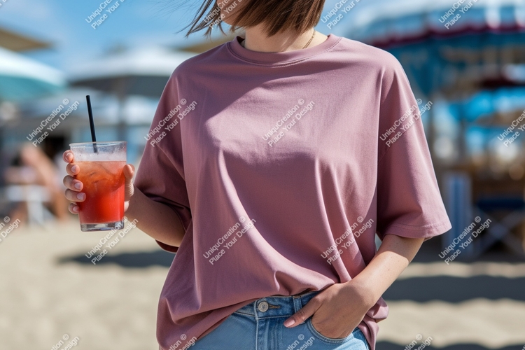 Pink shirt denim jeans holding drink beach glass