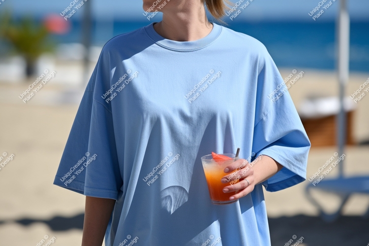 Blue shirt person holding drink beach