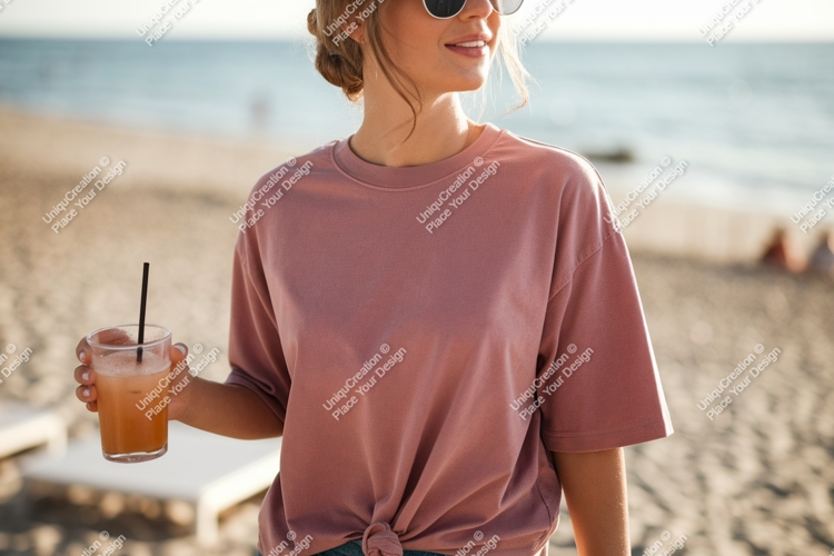 Woman holding drink on beach ocean sand