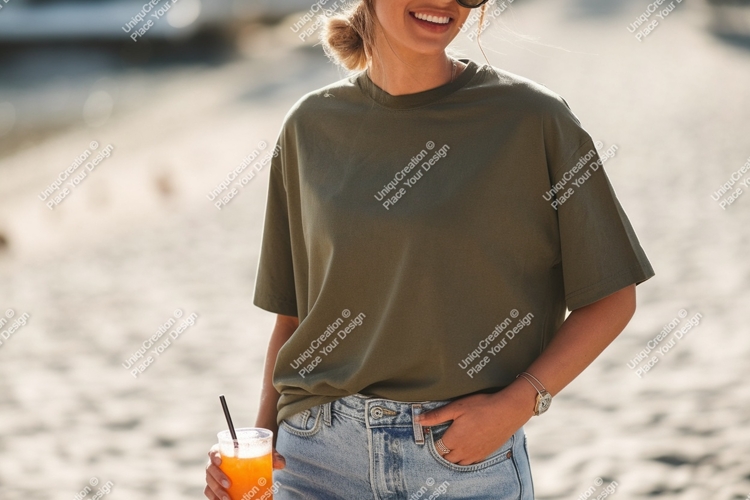 Woman wearing olive green t shirt holding orange drink