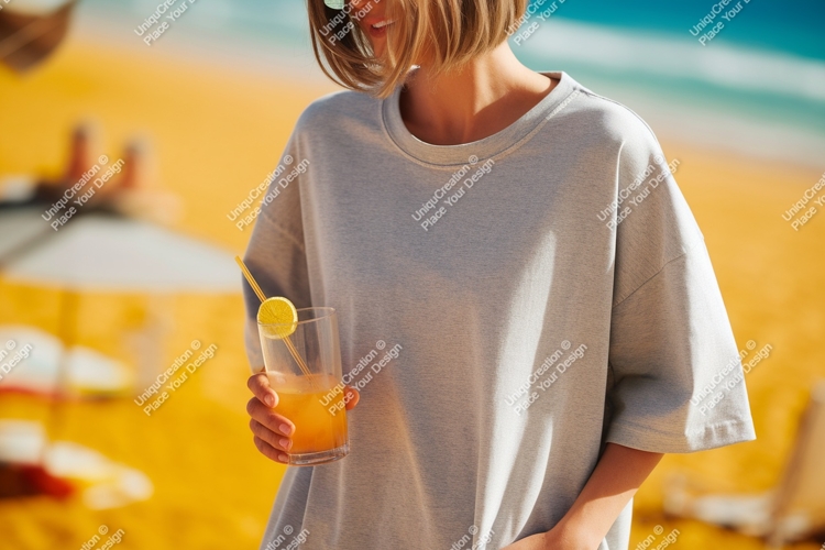 Woman holding orange drink on beach image