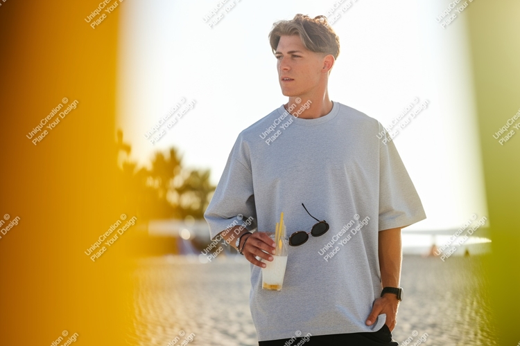 Man holding drink on beach sunglasses t-shirt