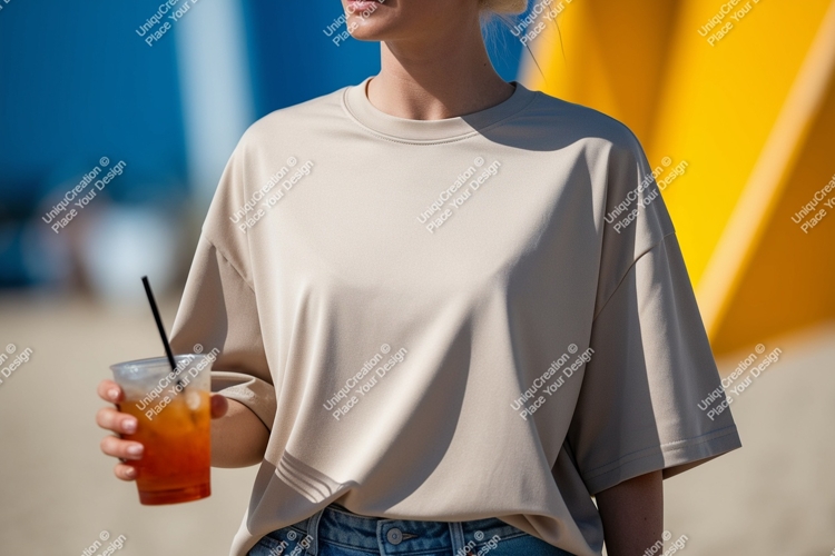 Beige t shirt holding orange drink image