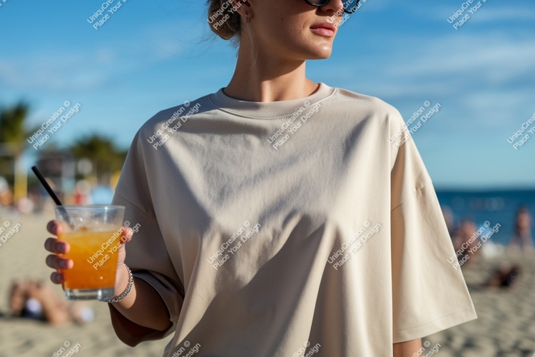 Woman holding orange drink on beach image