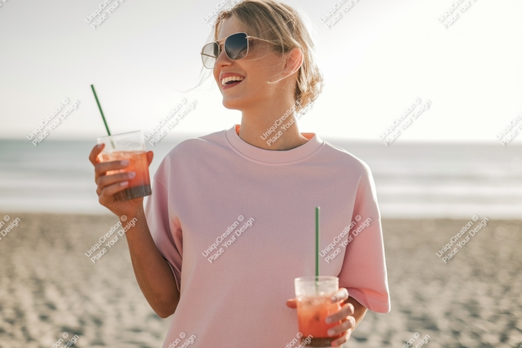 Woman holding pink drinks at beach sunglasses
