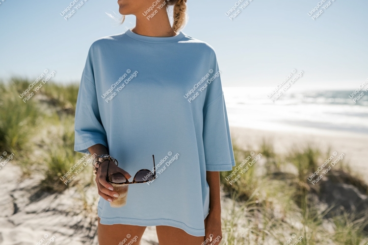 Woman wearing blue shirt on beach sand