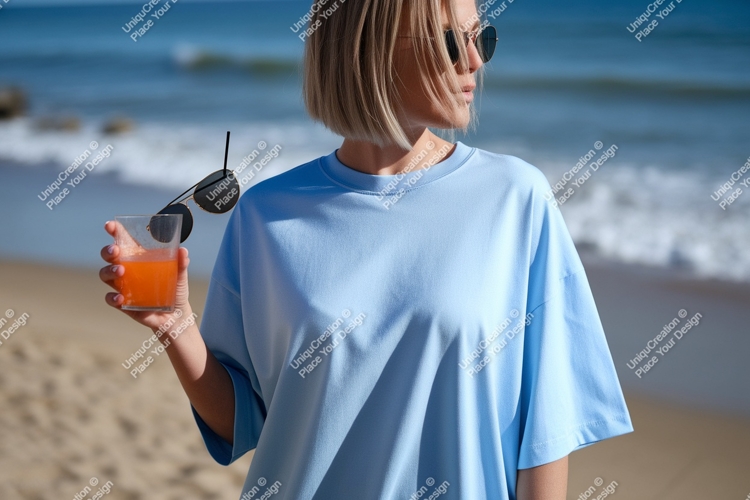 Woman holding drink on beach ocean