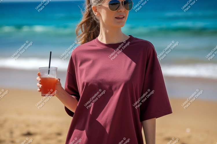 Woman holding drink on beach ocean