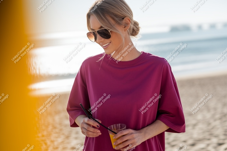Woman wearing magenta t shirt holding drink sunglasses