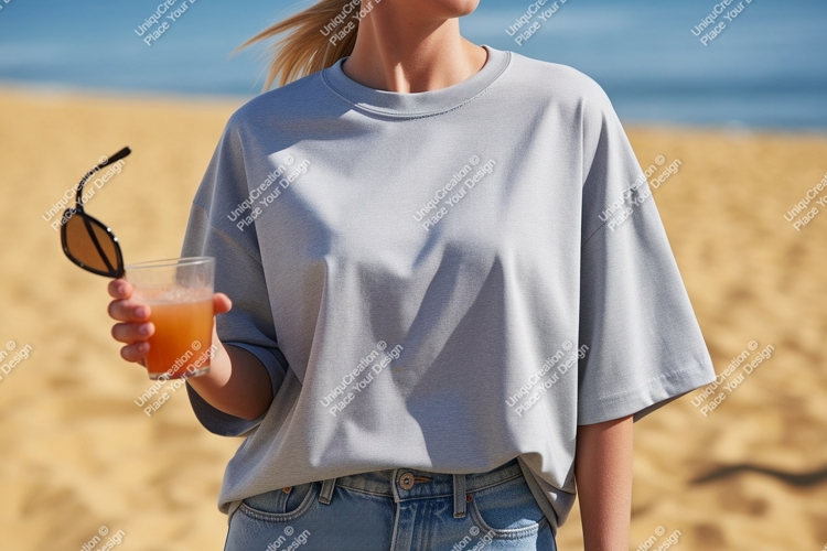 Woman wearing grey t shirt holding drink and sunglasses
