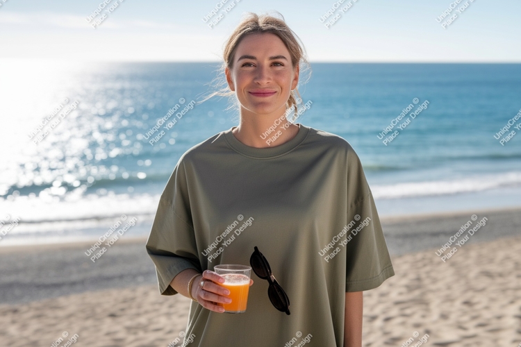 Woman holding drink on beach ocean sand