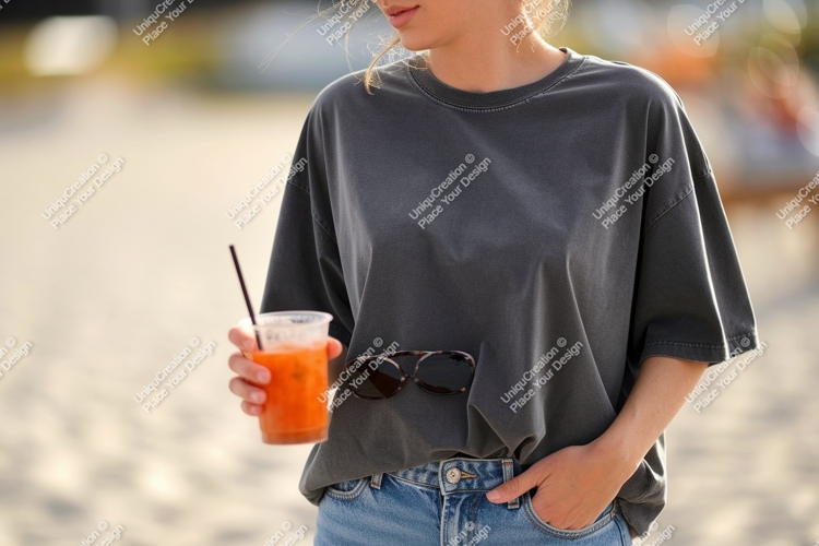 Woman holding orange drink sunglasses tucked into jeans