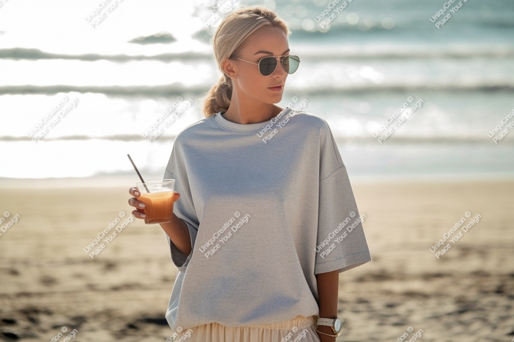 Woman holding drink on beach ocean sand