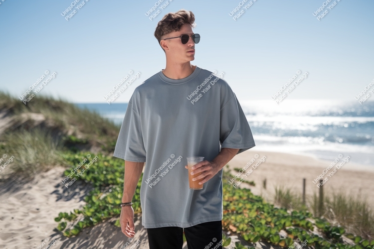 Man wearing grey t shirt holding drink image