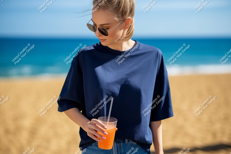 Woman holding orange drink on beach ocean