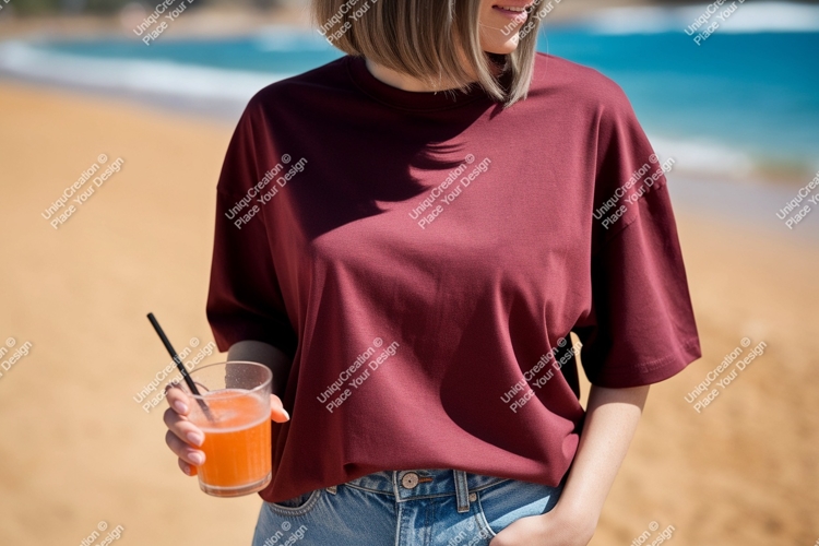 Woman holding orange drink on beach ocean sand