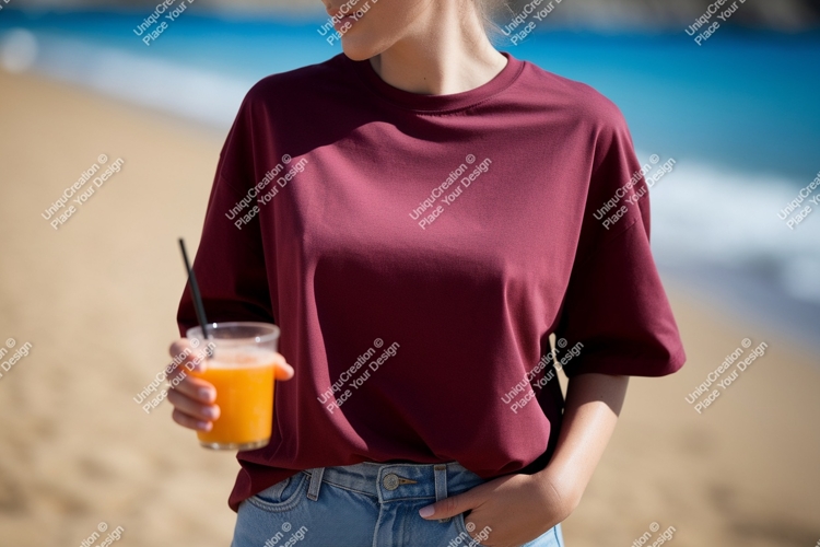 Maroon t shirt holding orange juice image