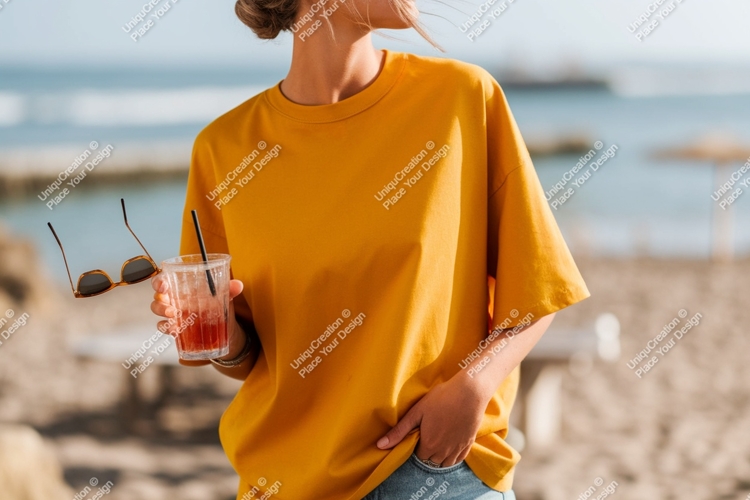 Woman wearing yellow t shirt holding drink image