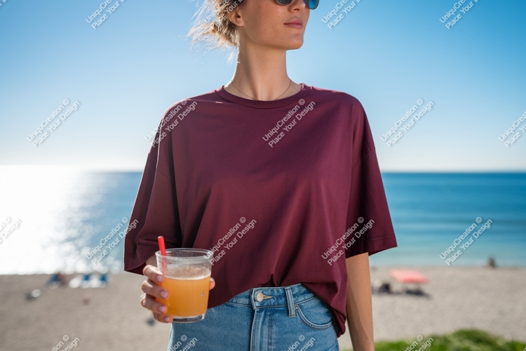 Woman wearing maroon t shirt holding orange drink t-shirt
