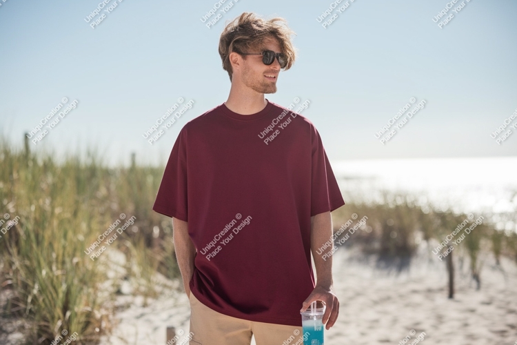 Man wearing maroon t shirt on beach image
