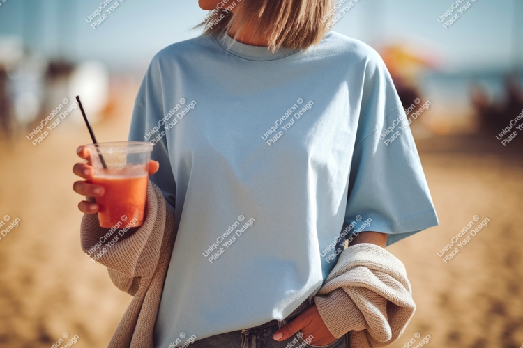 Light blue t shirt and orange drink image