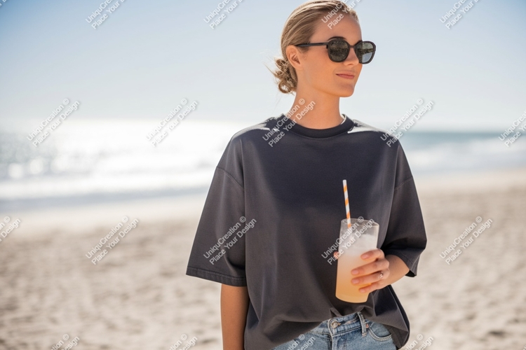 Woman holding drink on beach ocean sand