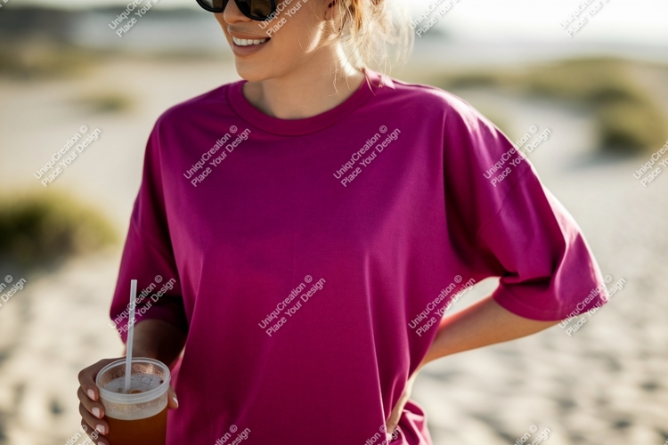 Woman wearing magenta t shirt holding drink image