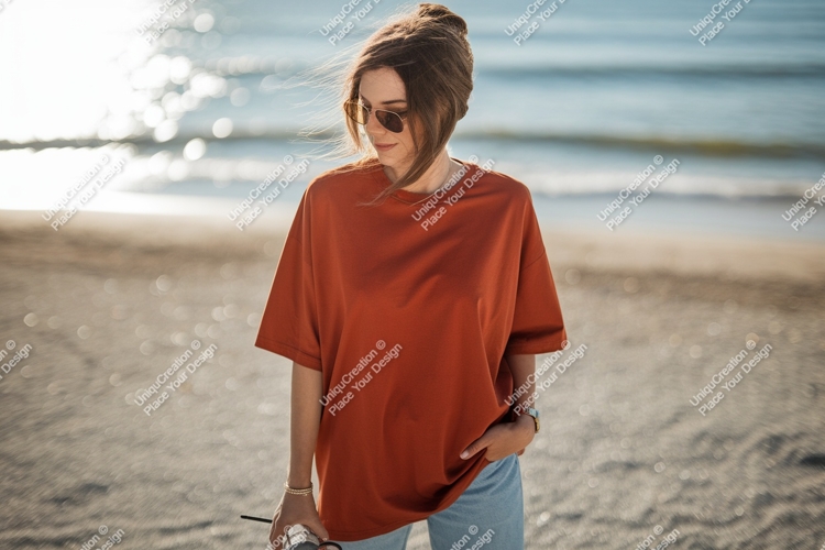 Woman wearing orange shirt on beach ocean