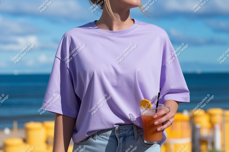 Woman wearing lavender t shirt holding orange drink
