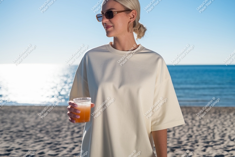 Woman holding drink on beach ocean sand