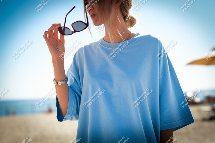 Woman holding sunglasses blue shirt beach image