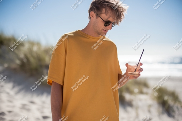 Man wearing yellow t shirt holding drink t-shirt beach