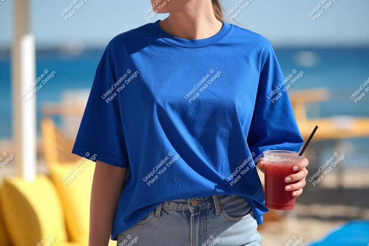 Blue shirt person holding drink beach