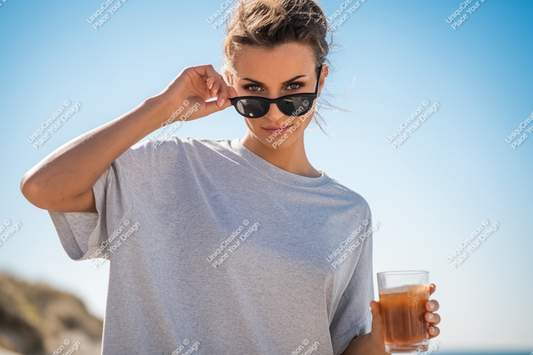 Woman sunglasses holding drink blue sky shirt