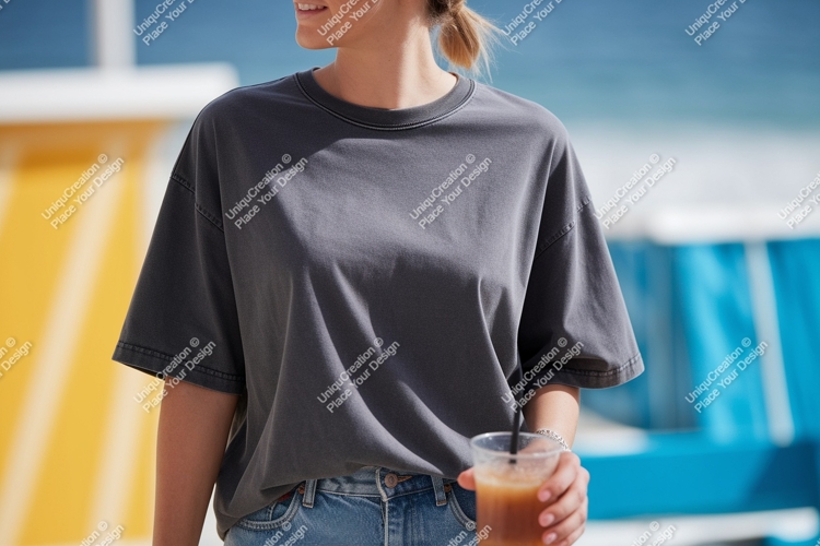 Woman holding iced coffee wearing grey t shirt denim