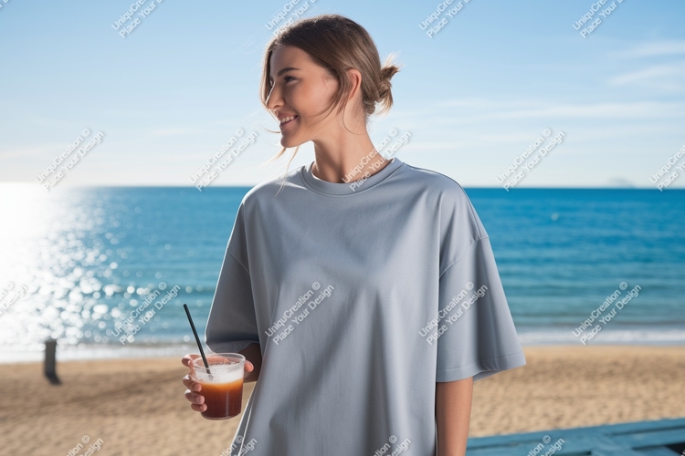 Woman holding drink on beach ocean