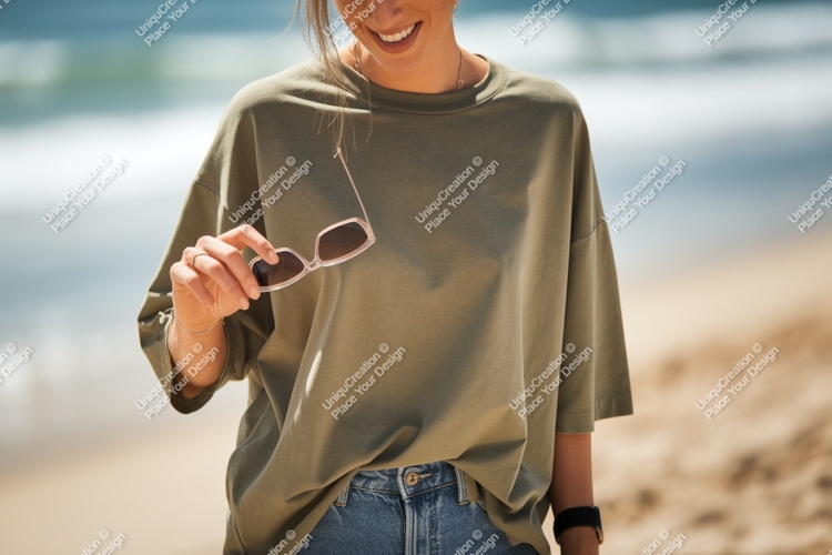 Woman holding sunglasses at beach ocean