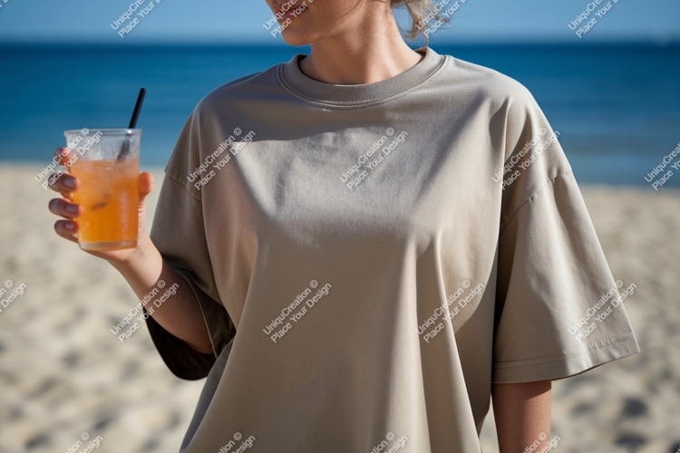 Woman holding drink on beach ocean sand