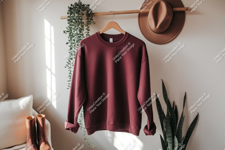 Maroon sweatshirt hanging on wooden rod clothing apparel