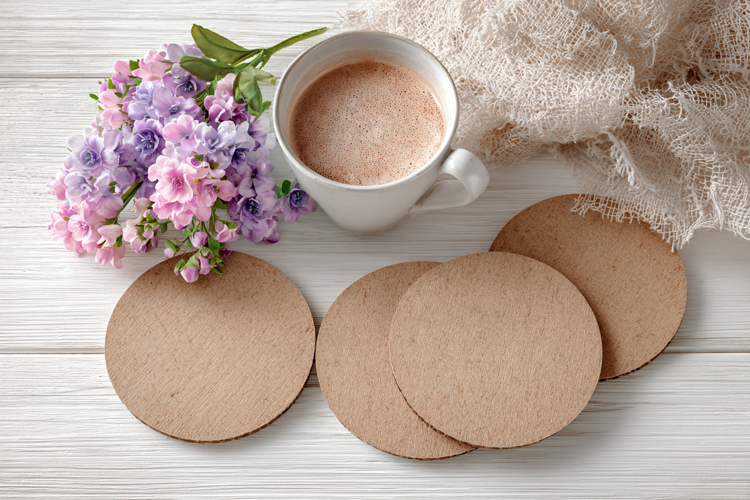 Four Blank Round Coasters Mockup with Cup and Flowers