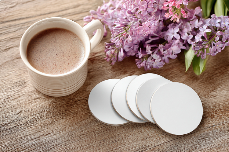Four Blank Round Coasters Mockup with Cup and Flowers