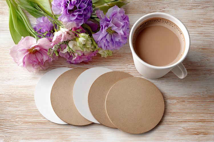 Four Blank Round Coasters Mockup with Cup and Flowers