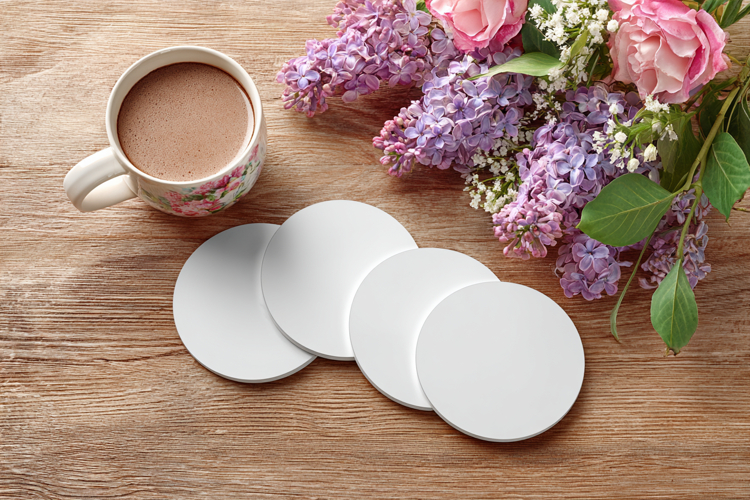 Four Blank Round Coasters Mockup with Cup and Flowers