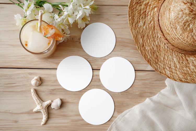 Four Blank Round Coasters Mockup with Cup and Flowers