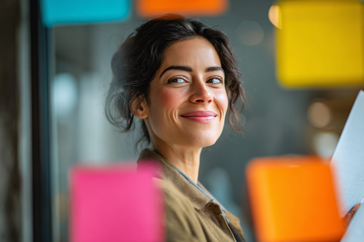 Businesswoman Using Sticky Notes on Glass
